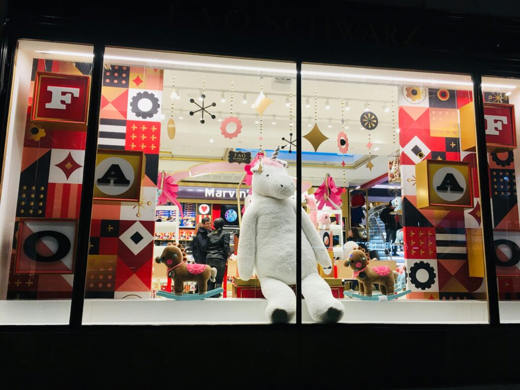 Storefront with large teddy bear display.