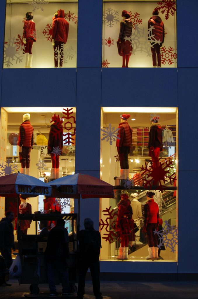Storefront mannequins with winter clothing and snowflakes.